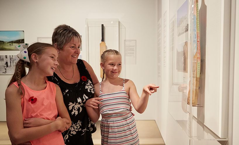 A family explore exhibits at the Shrine of Remembrance