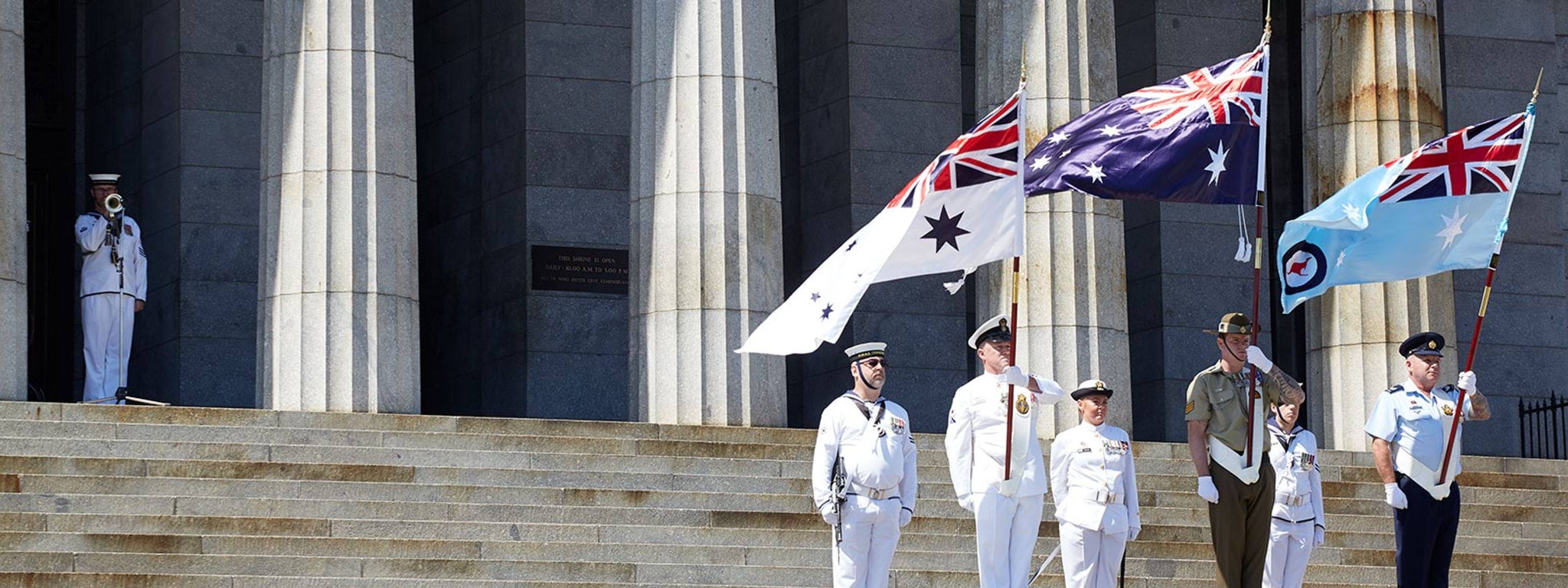 Donate banner Tri-service flag party on the steps of the Shrine