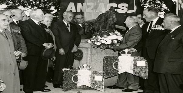 Men from the Gallipoli Legion of Anzacs laying a wreath beneath Wallace Anderson's Man with the Donkey sculpture, Gascard Collection, The Age, 1933-75