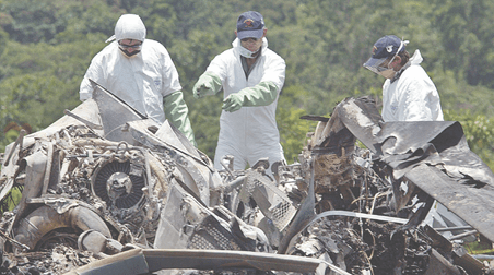 Australian military personnel examine the wreckage of Shark 02