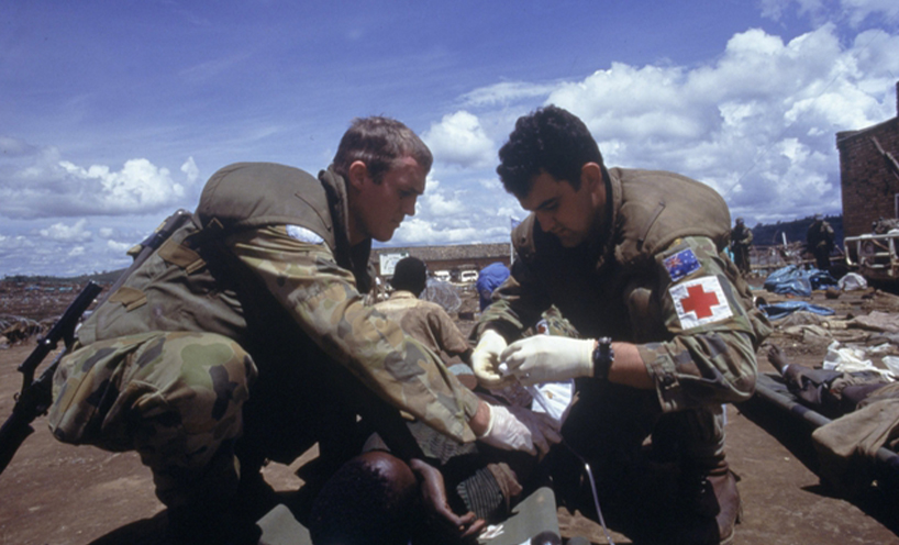 Two Australian soldiers treating a wounded Rwandan at the Kibeho refugee camp April 1995