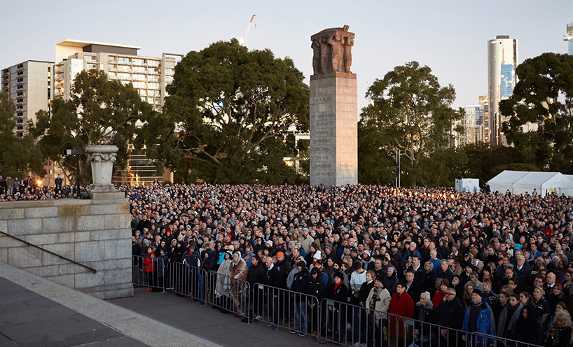 A large crowd is gathered at the steps of the Shrine of Remembrance for the Anzac Day Dawn Service