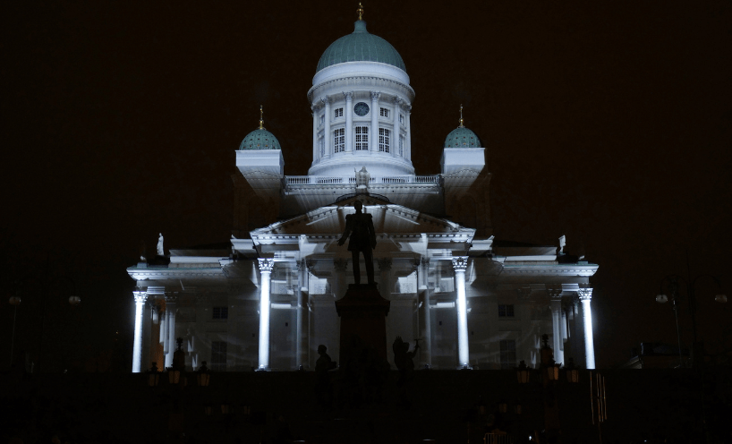 A black and white photo featuring an atmospherically lit building